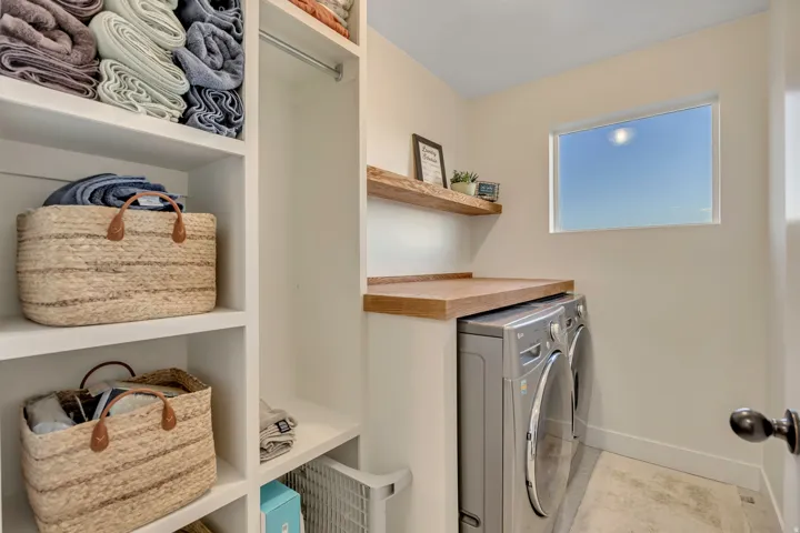 Laundry area featuring washer and clothes dryer and baseboards