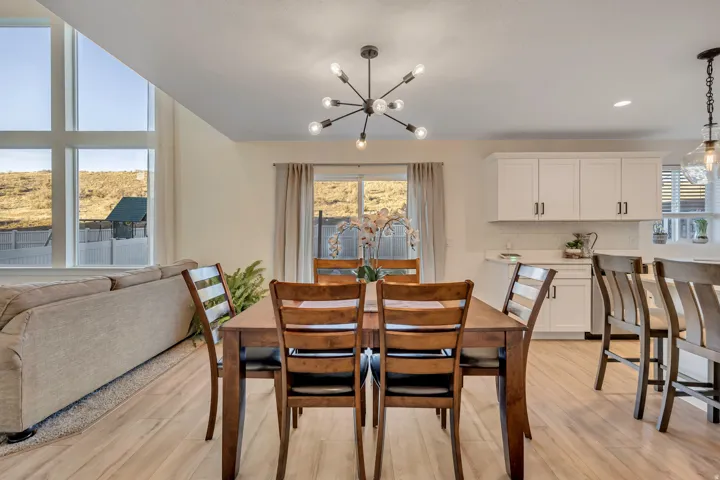 Dining area featuring suspended lighting, light wood-type flooring, and healthy amount of natural light