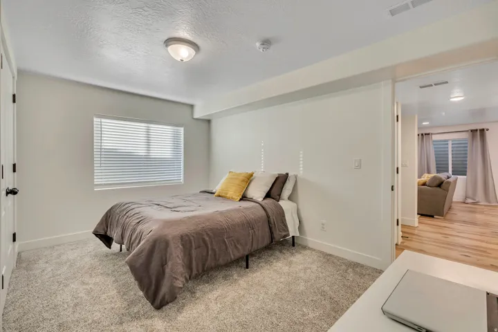Bedroom featuring light carpet and a textured ceiling