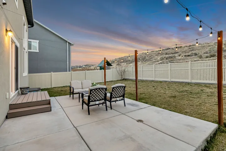 Patio terrace at dusk featuring a patio area, a fenced backyard, and an outdoor lounge area