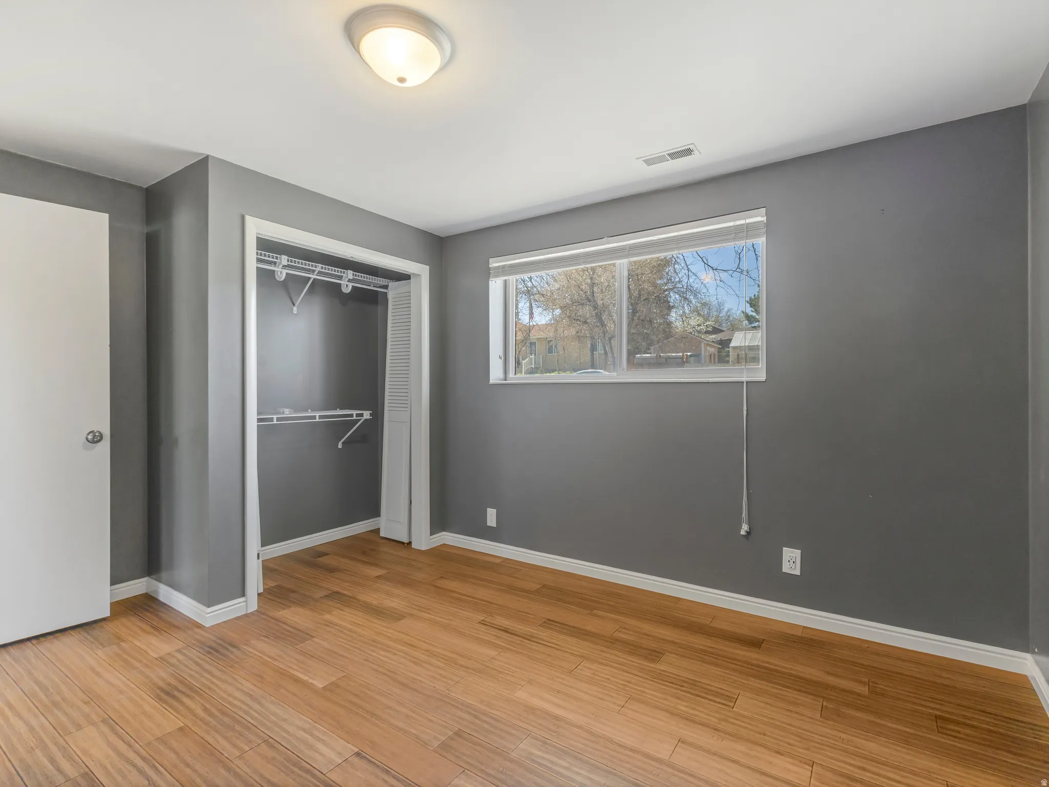 Unfurnished bedroom featuring a closet and light wood-type flooring