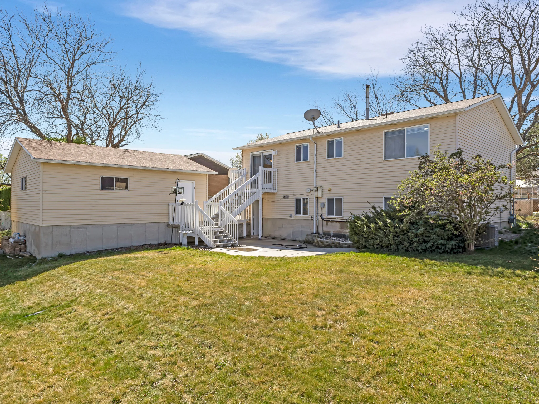 Back of property featuring a yard