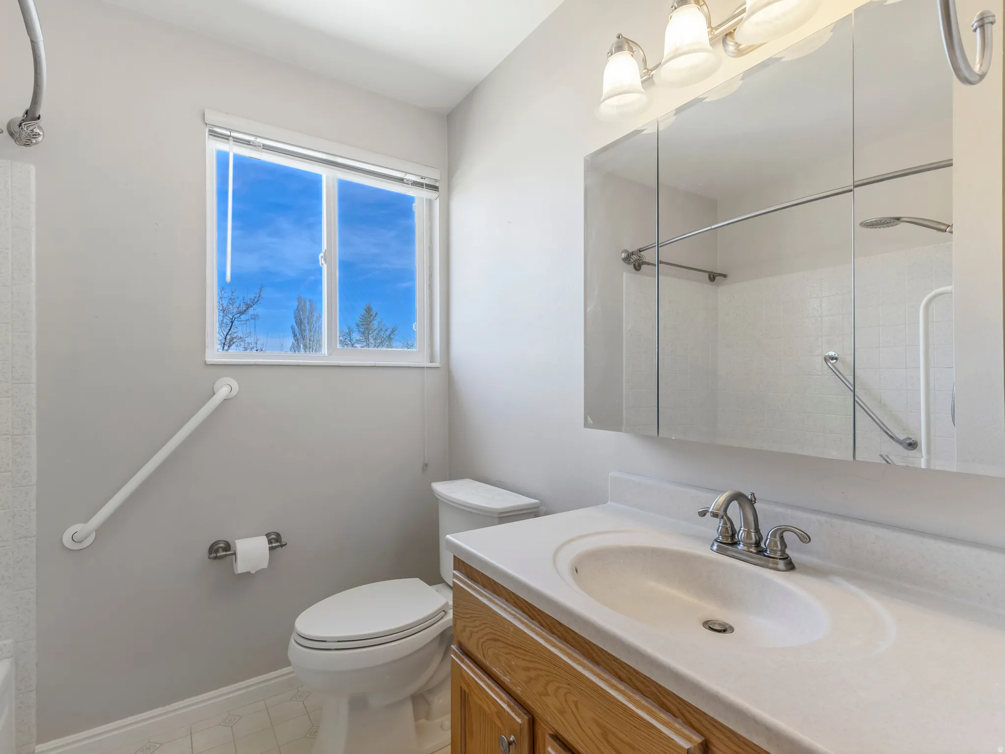 Bathroom with vanity and bathtub / shower combination