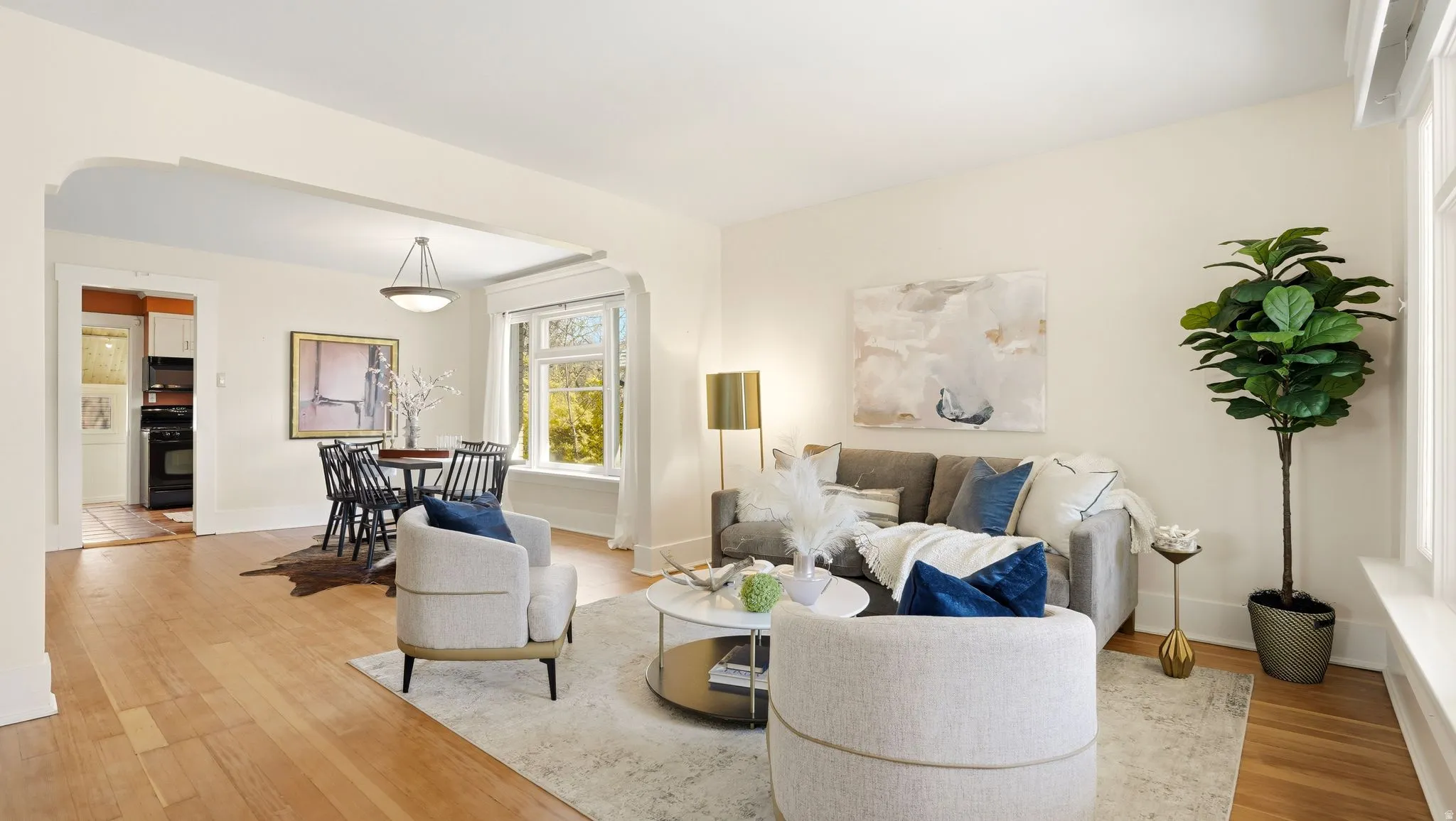 Living room featuring light wood-style floors and arched walkways