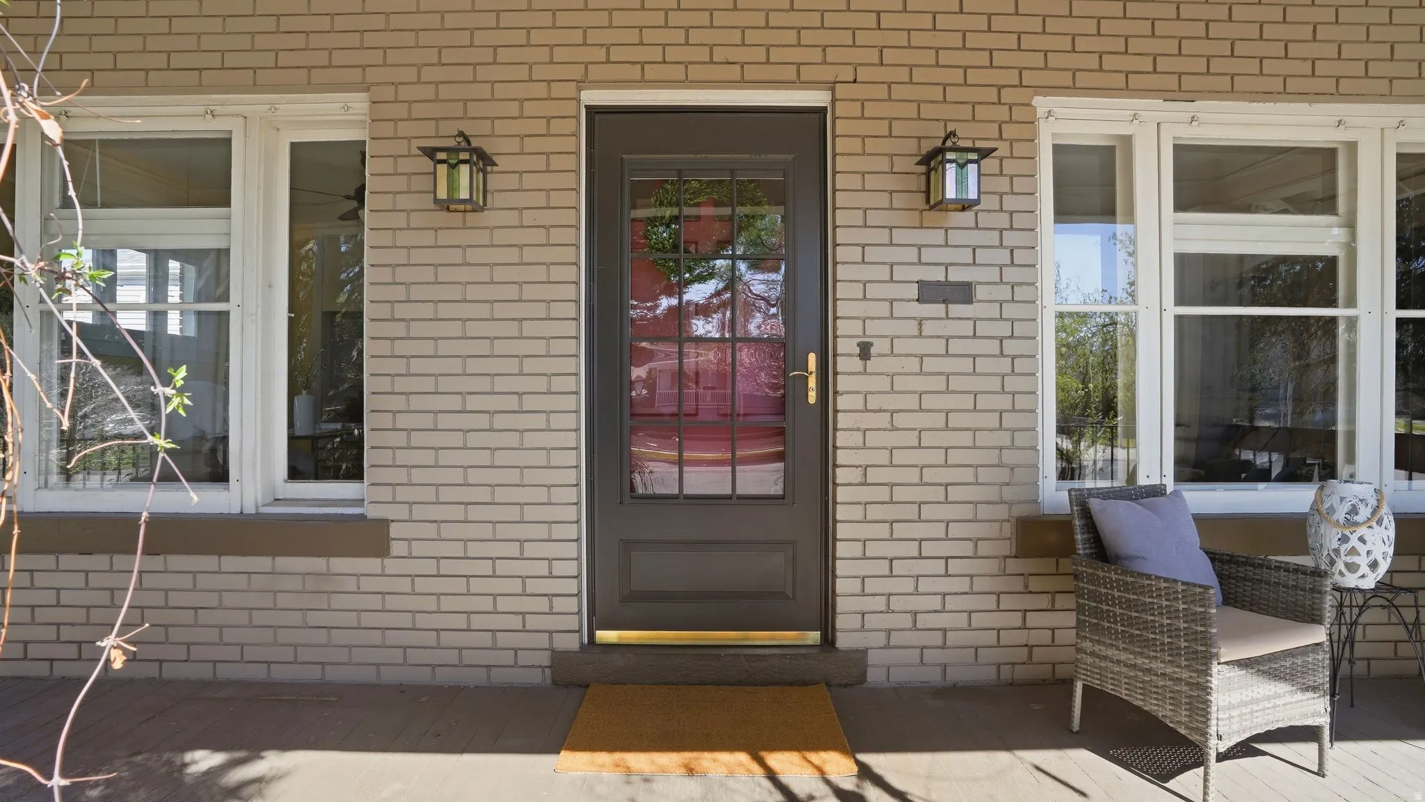 Property entrance featuring brick siding