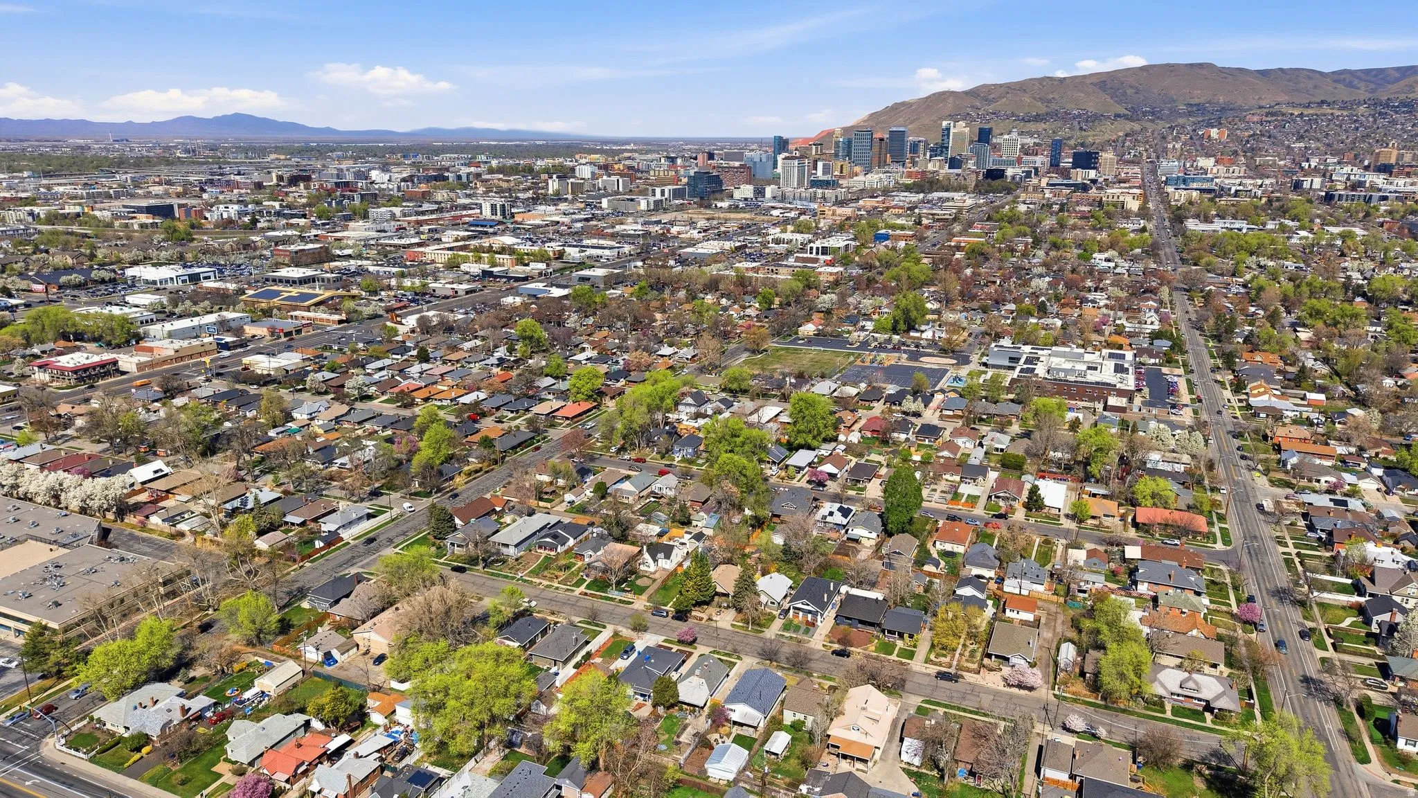Aerial overview of property's location with a mountainous background and nearby suburban area