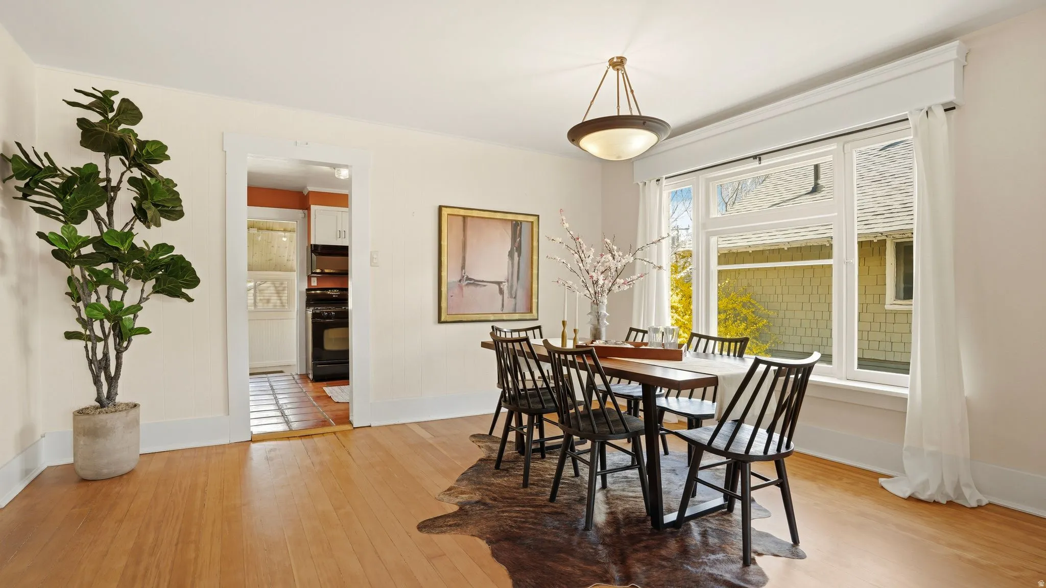 Dining room with light wood-type flooring and baseboards