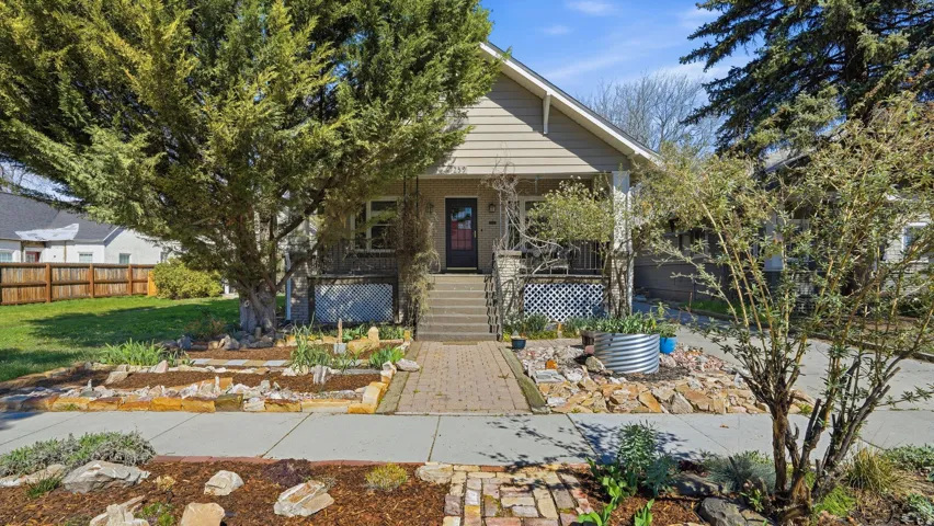 View of front of home with covered porch and brick siding