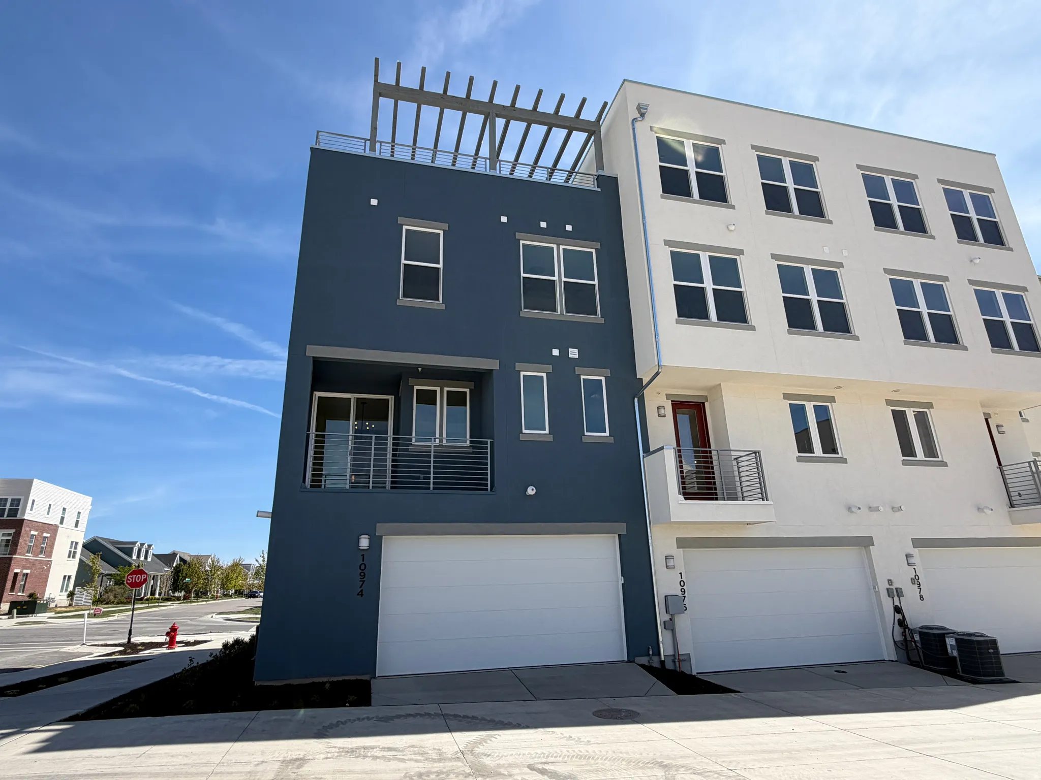 View of front facade with a balcony, stucco siding, a garage, and concrete driveway