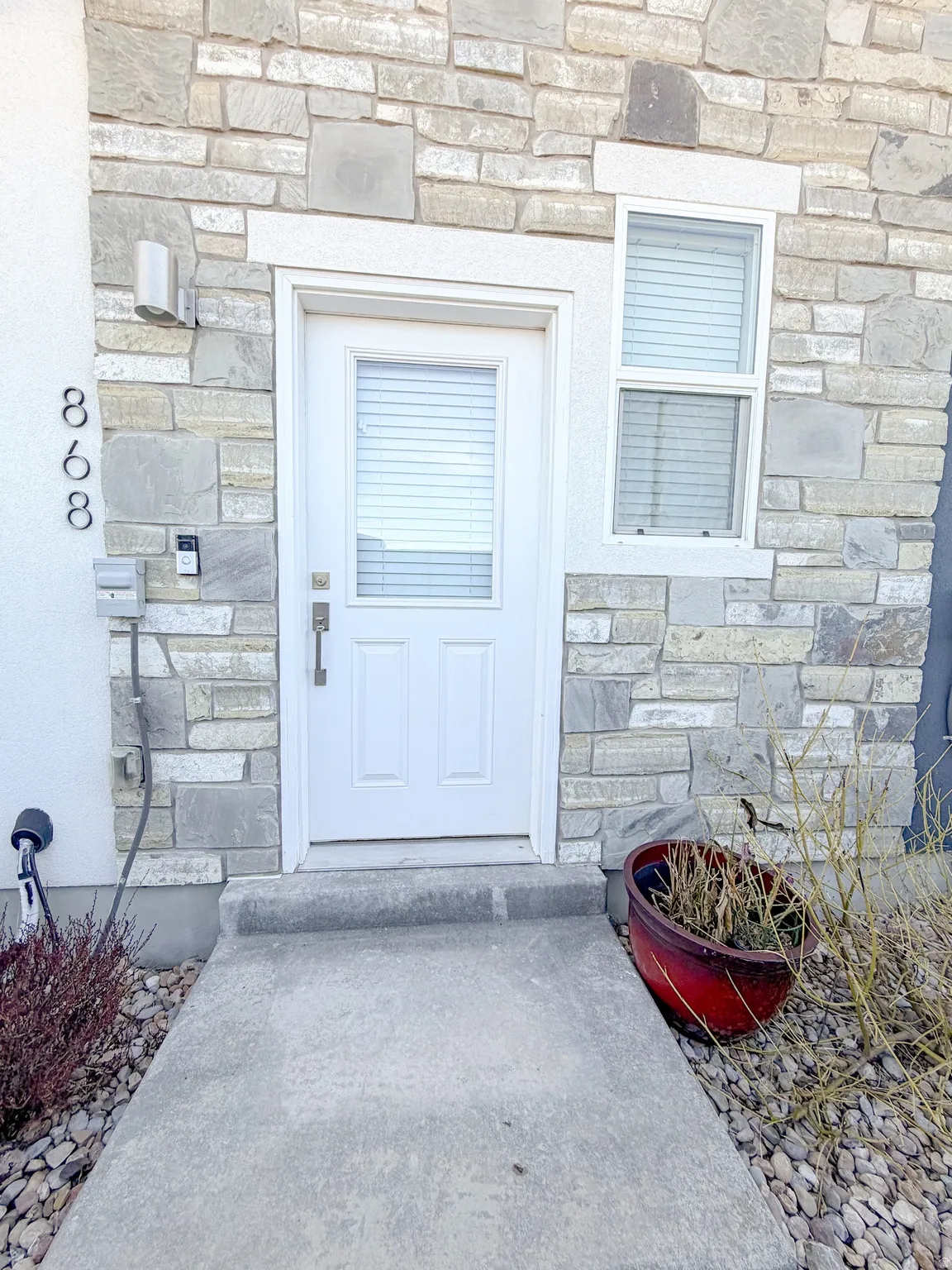 View of exterior entry with stone siding
