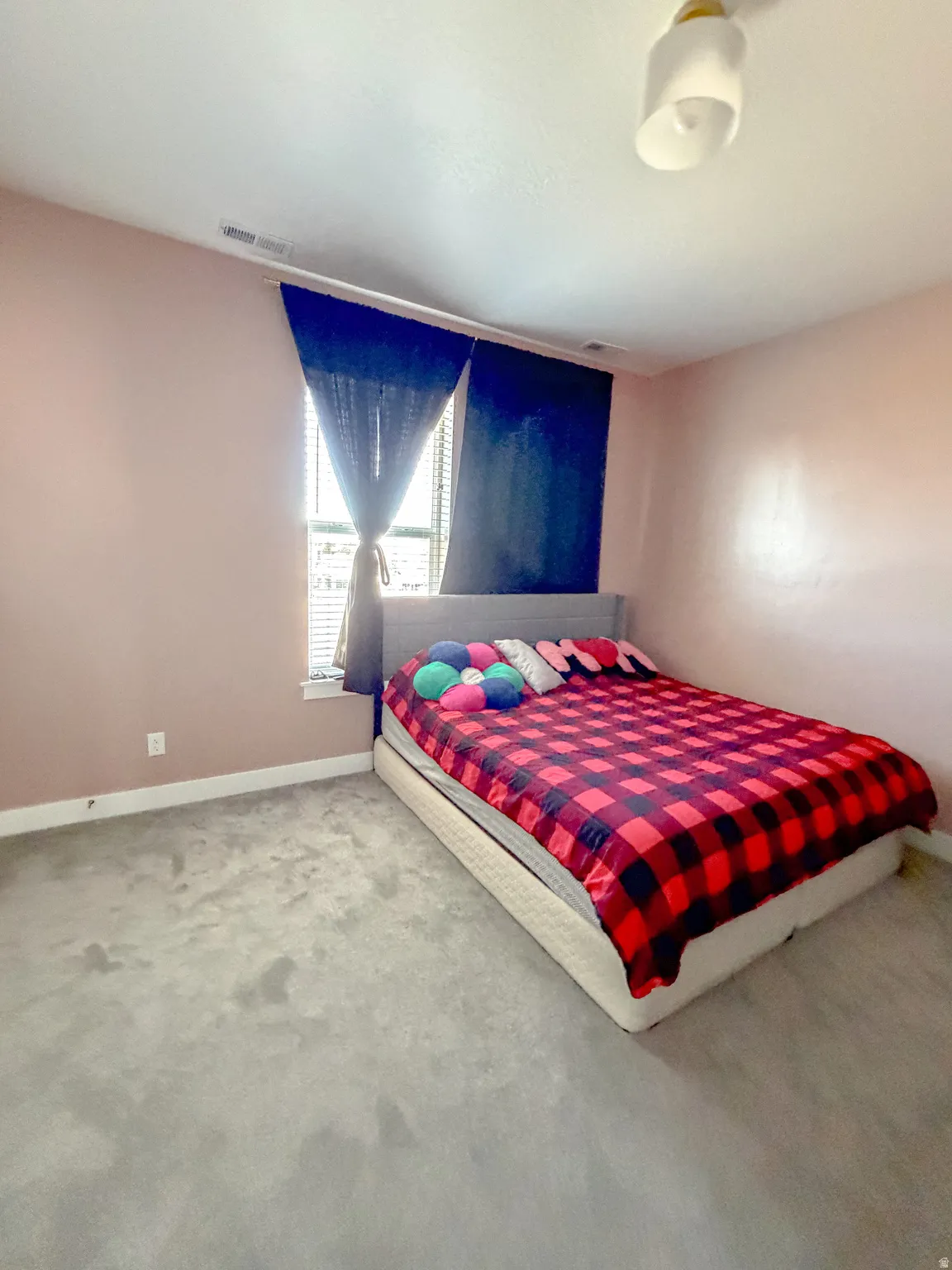 Bedroom featuring light colored carpet