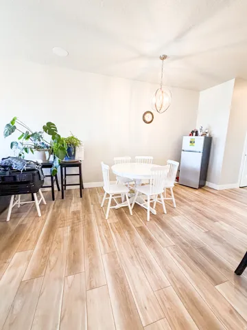 Dining area featuring light wood-style flooring and a chandelier