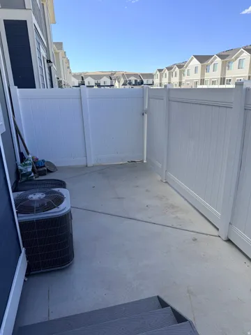 View of patio with a residential view and a gate