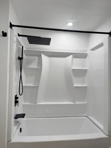 Bathroom featuring shower / washtub combination
