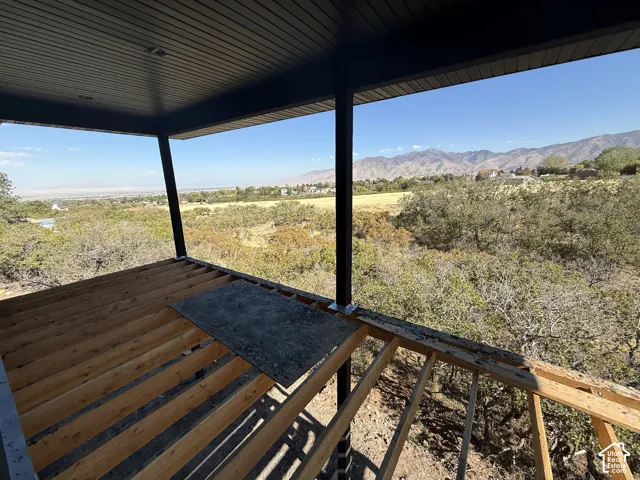 Expansive outdoor deck framing with a dark soffit ceiling and structural posts