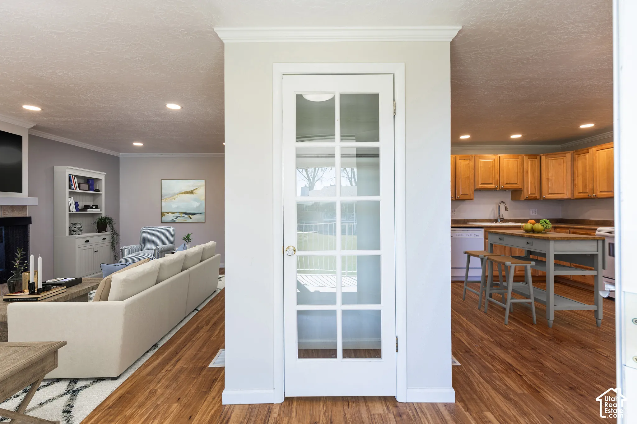 Hardwood-finish flooring throughout, French doors with multiple lites, recessed lighting, crown molding, and built-in cabinetry