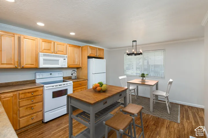 Kitchen featuring wood-finish flooring, recessed lighting, wood cabinetry, and a built-in microwave