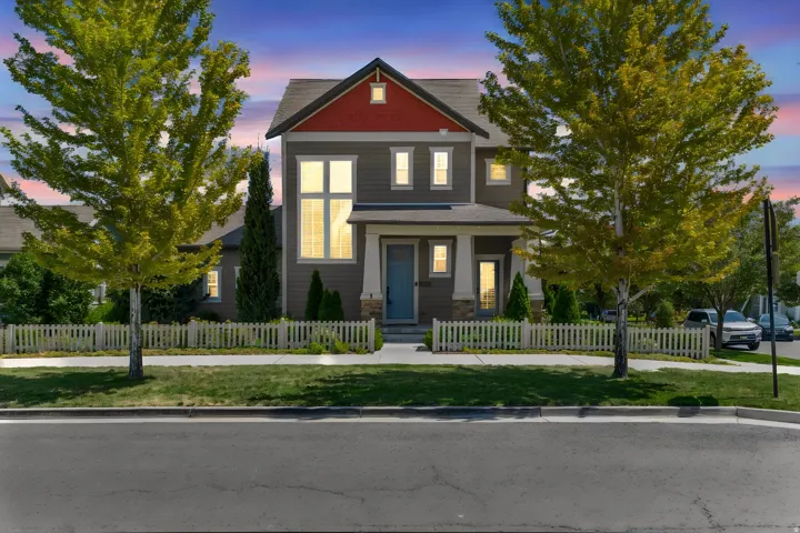 Multi-story exterior with a red gable accent and grey siding