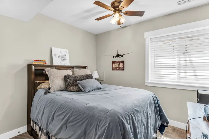 Recessed ceiling, neutral wall paint, ceiling fan with light fixture, window with blinds, carpeted flooring