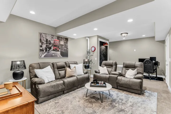 Recessed lighting, painted walls, carpeted flooring, built-in ceiling beams, and a flush-mount light fixture