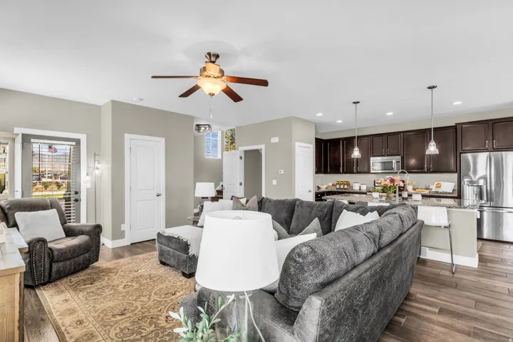 Open-concept living area featuring wood-finish flooring, a ceiling fan, and recessed lighting