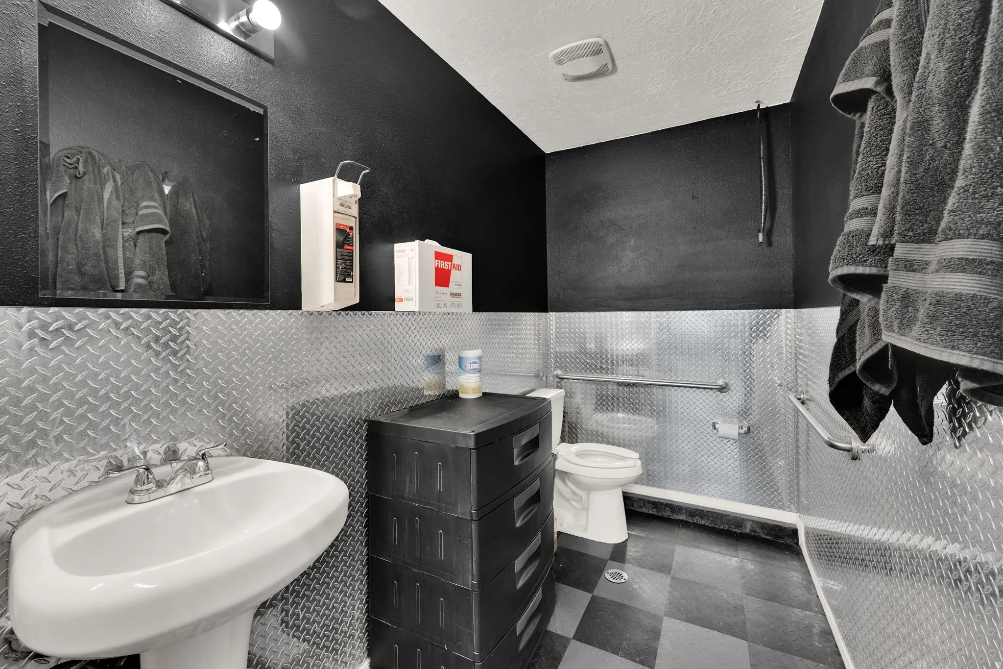 Bathroom with tile walls and a textured ceiling