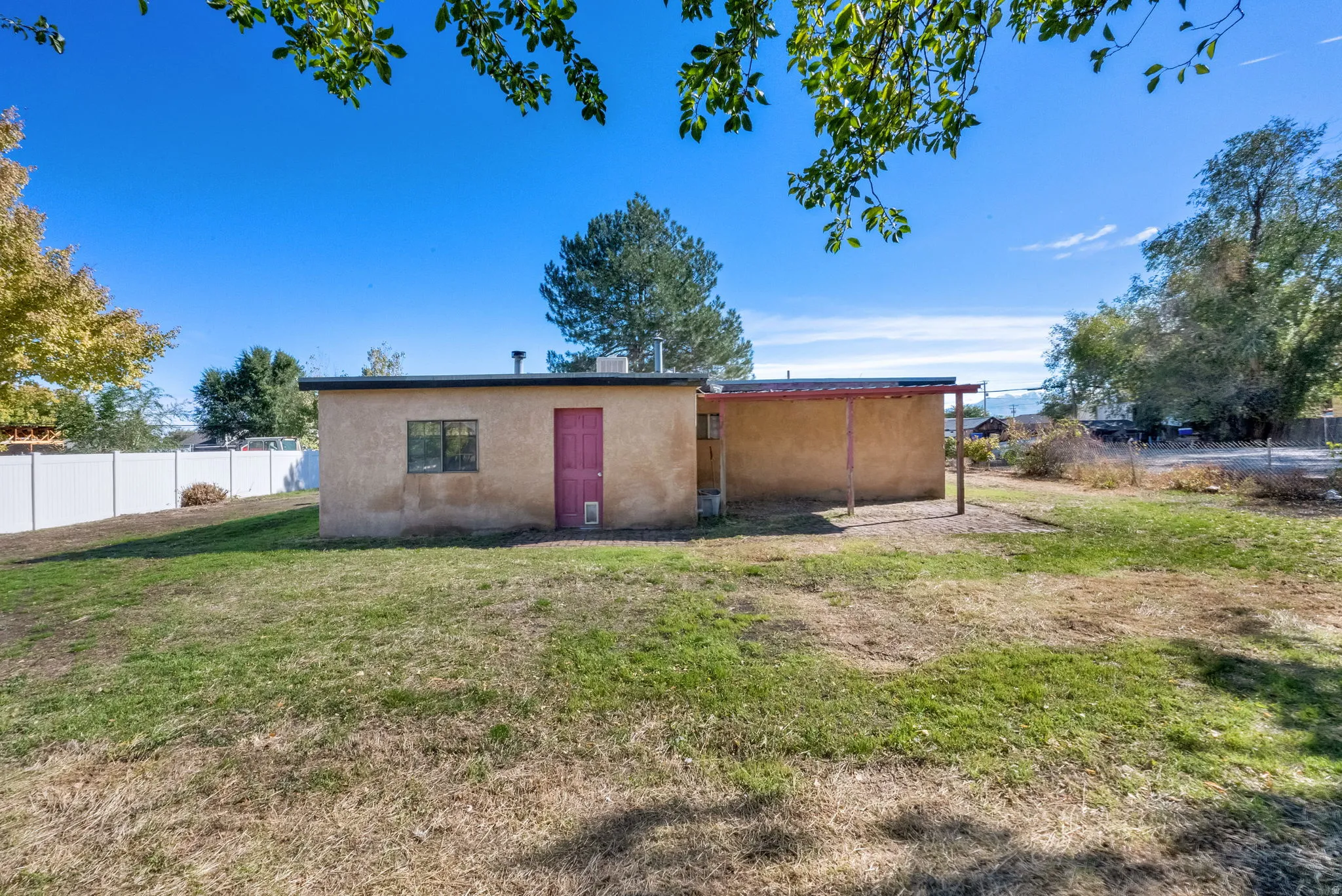 Rear view of property featuring stucco siding