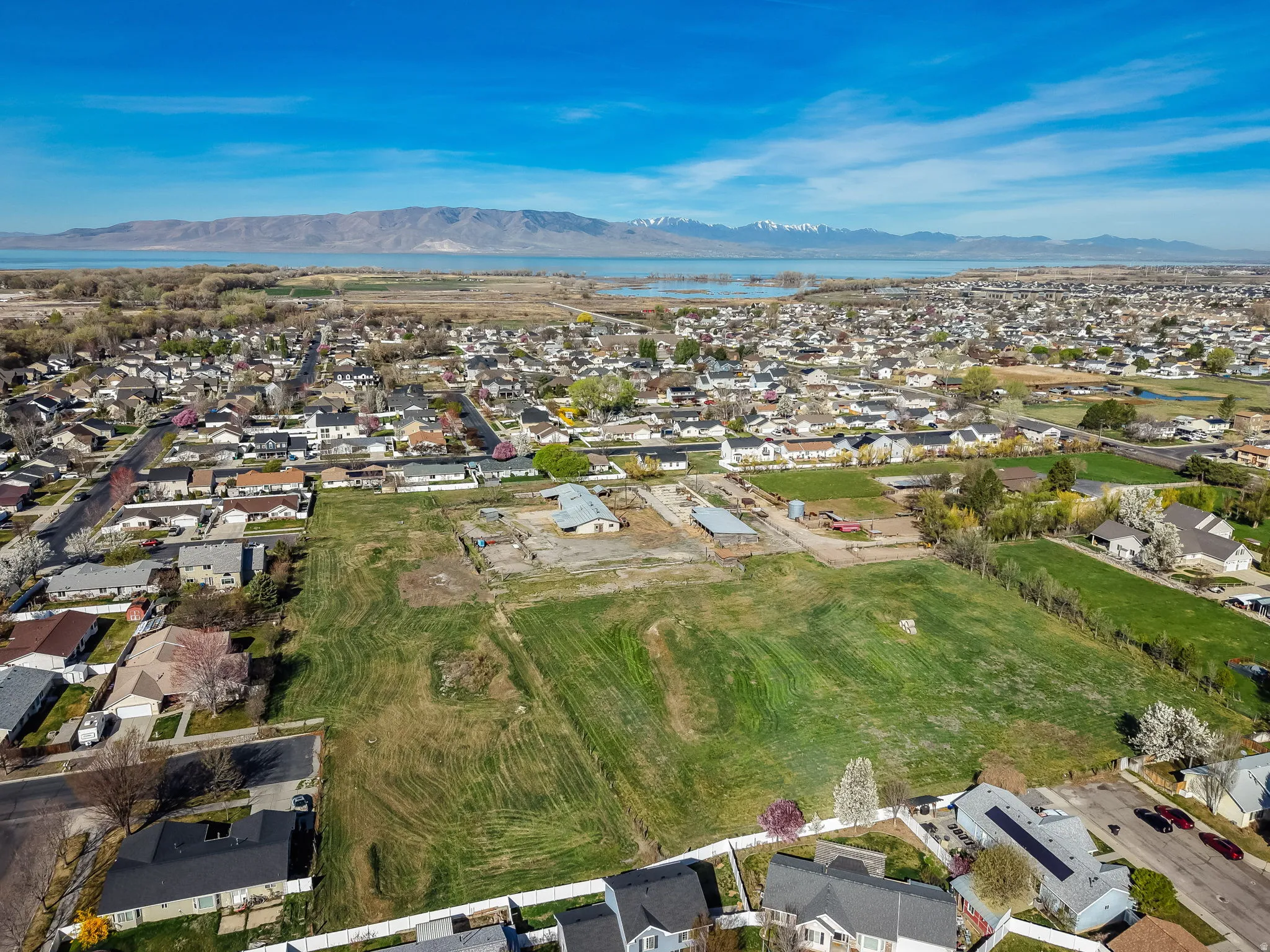 Aerial overview of property's location featuring nearby suburban area and a mountain backdrop