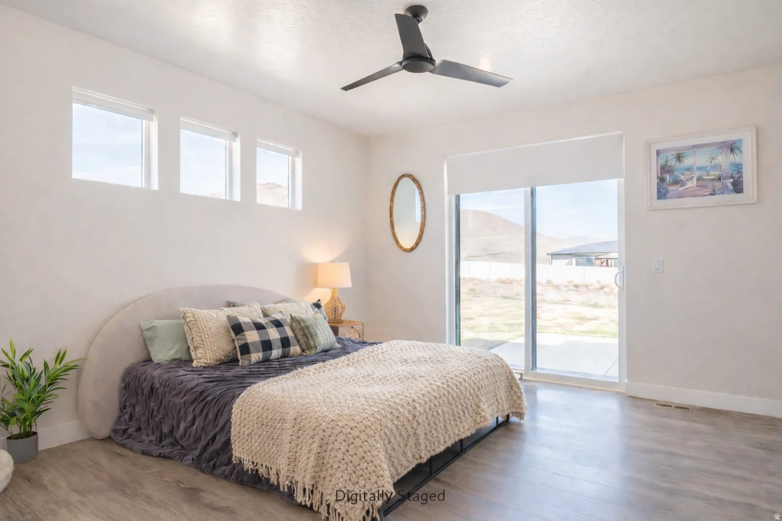 Bedroom featuring wood finished floors, access to exterior, and a ceiling fan