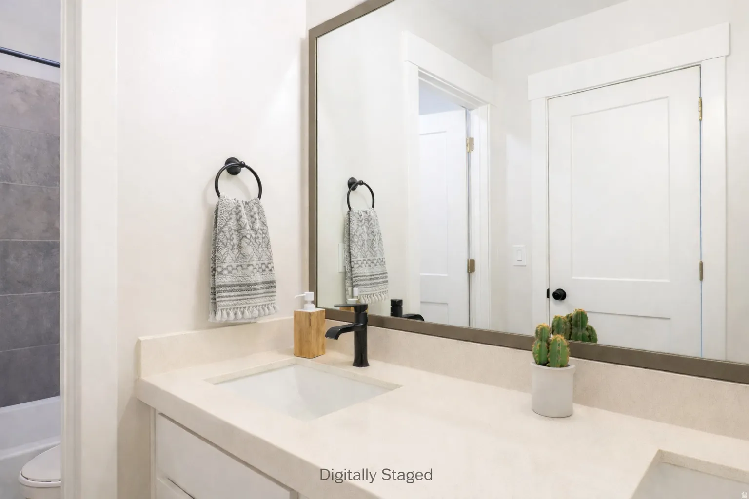 Bathroom featuring vanity and washtub / shower combination