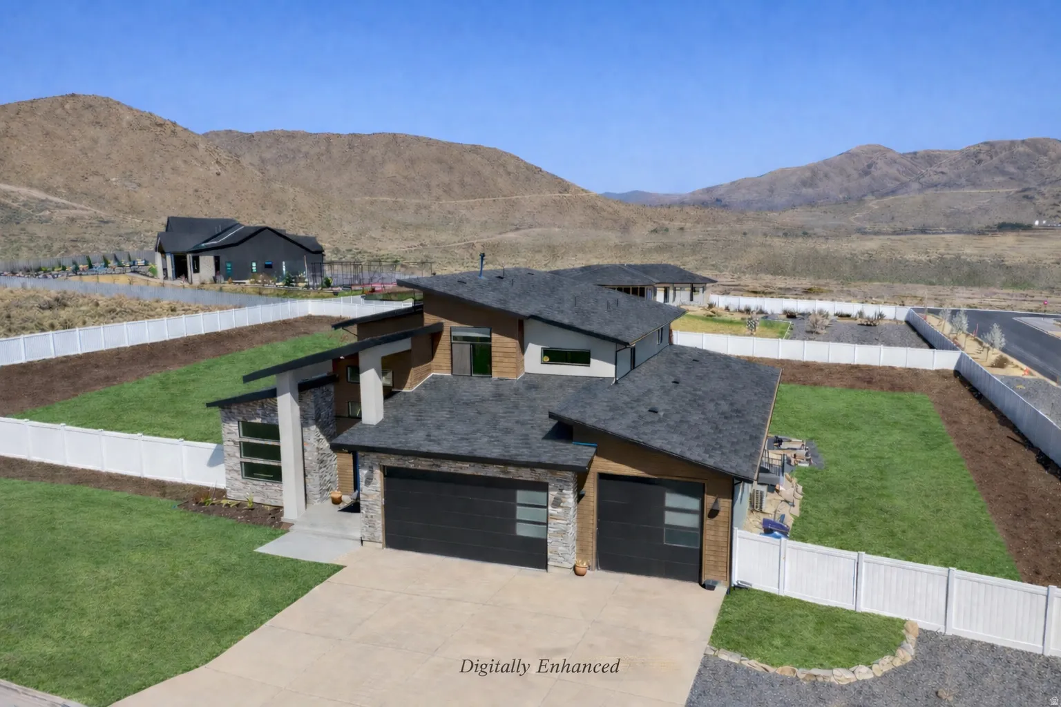 Modern home featuring driveway, a mountain view, and a garage