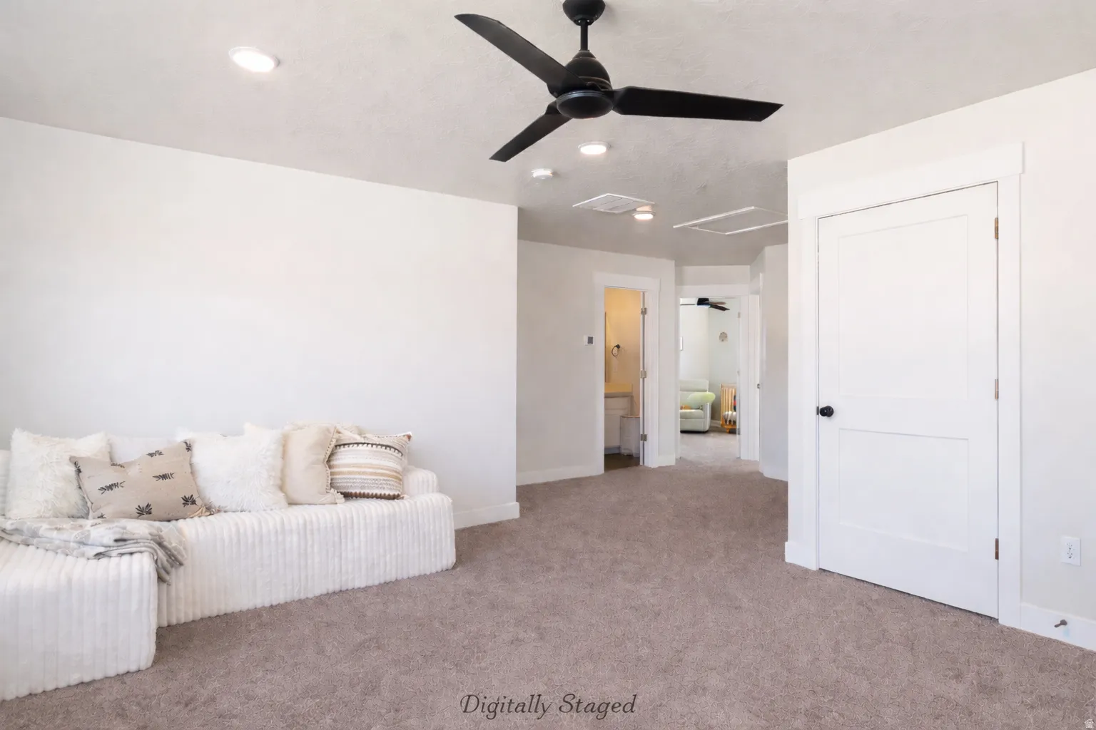 Living area featuring ceiling fan and carpet flooring