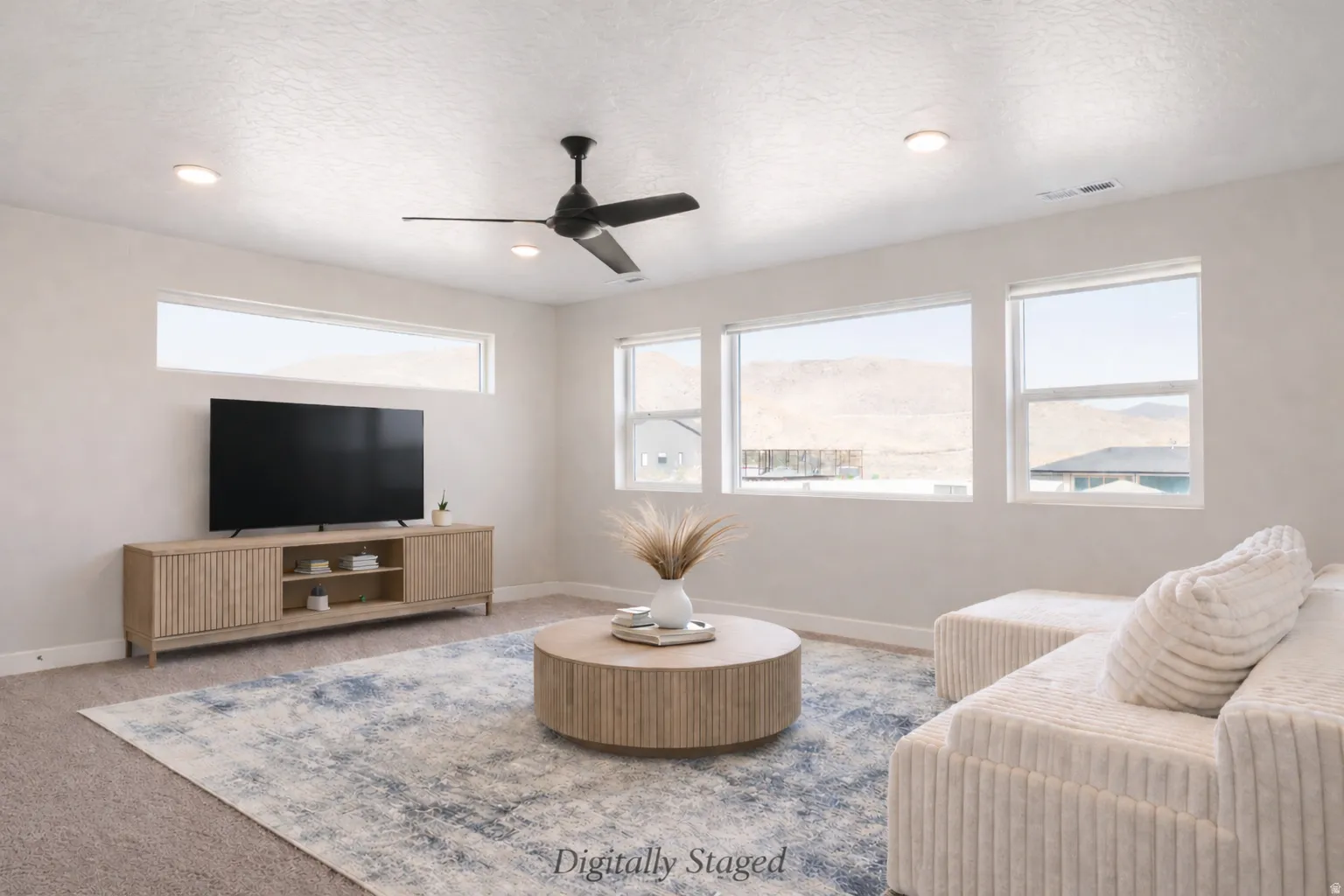 Living area with carpet flooring, ceiling fan, a textured ceiling, and recessed lighting