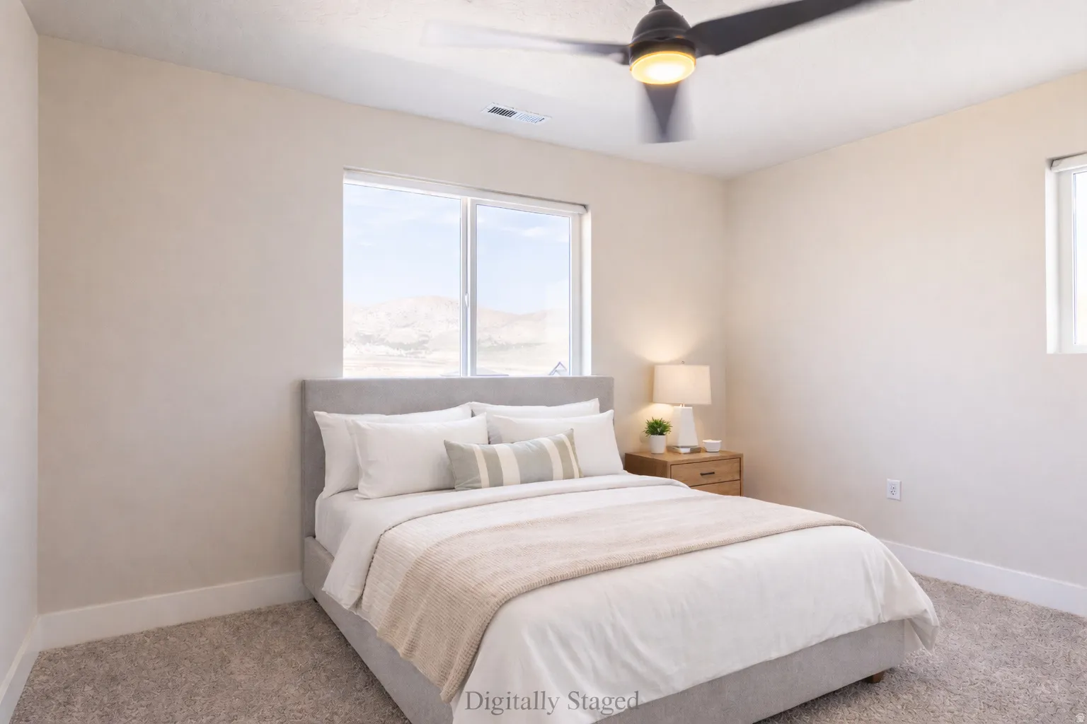 Bedroom featuring light colored carpet and ceiling fan