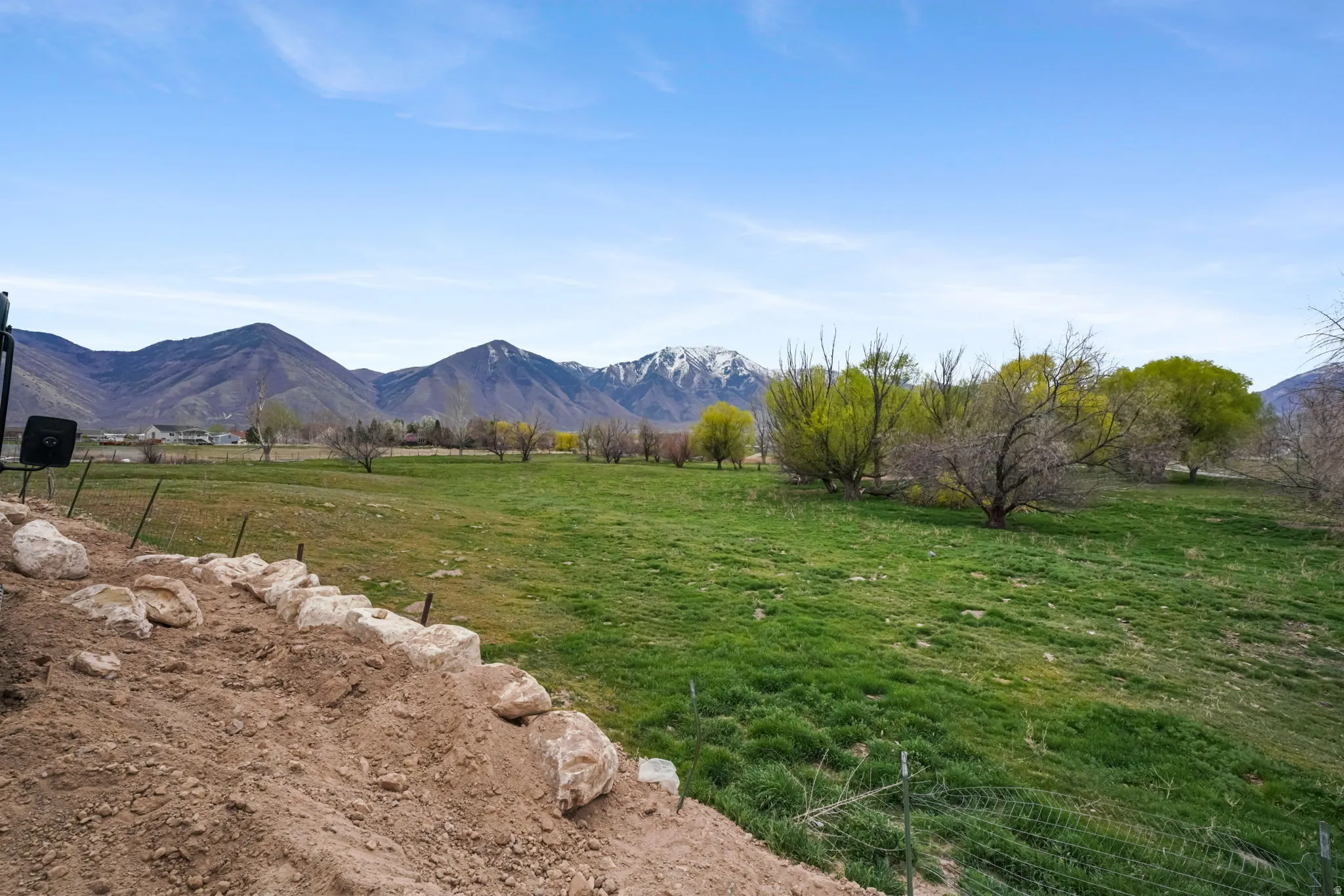 View of mountain backdrop featuring rural landscape and agricultural land