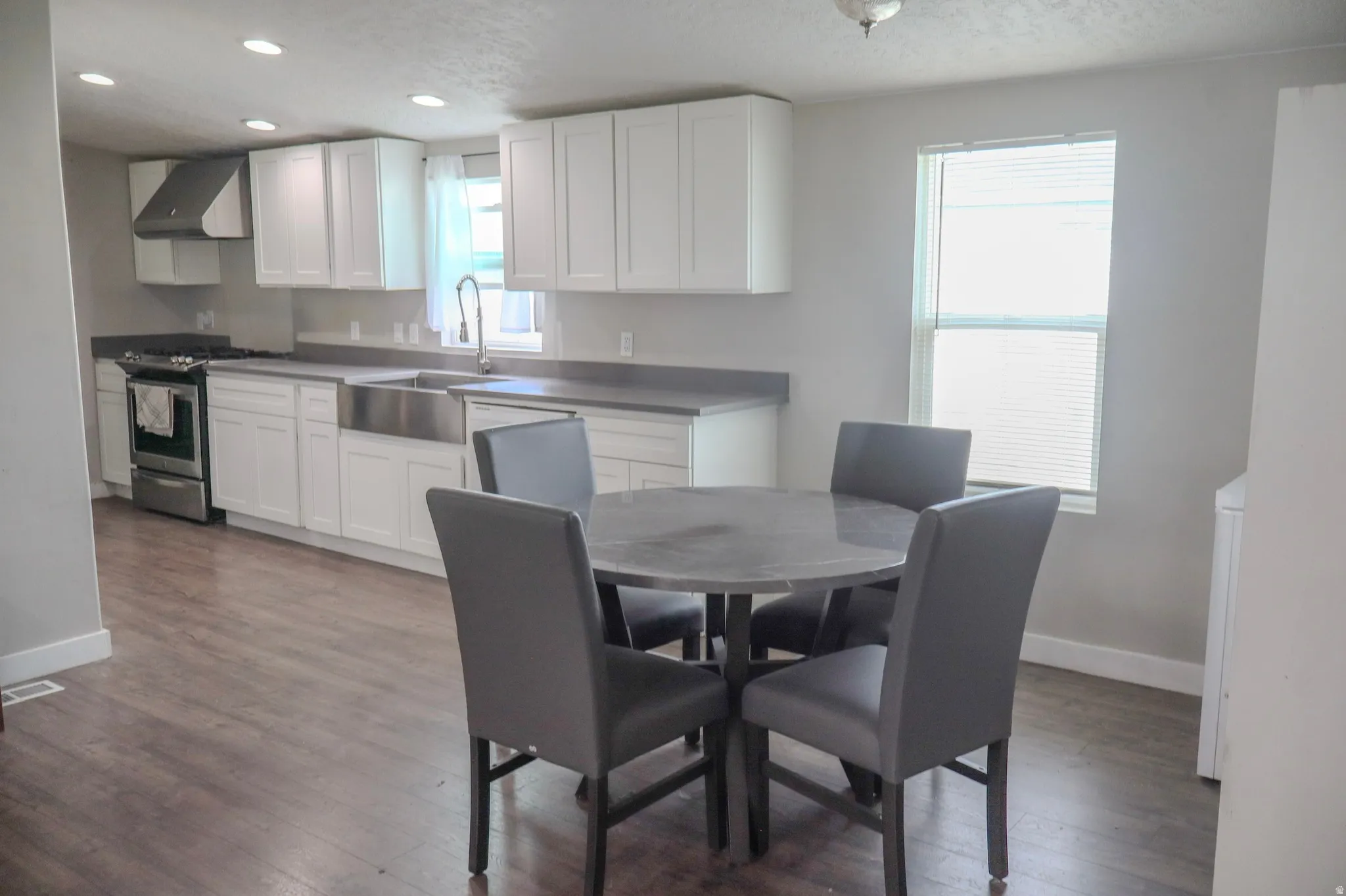 Kitchen and Dining room with dark wood-style flooring and recessed lighting