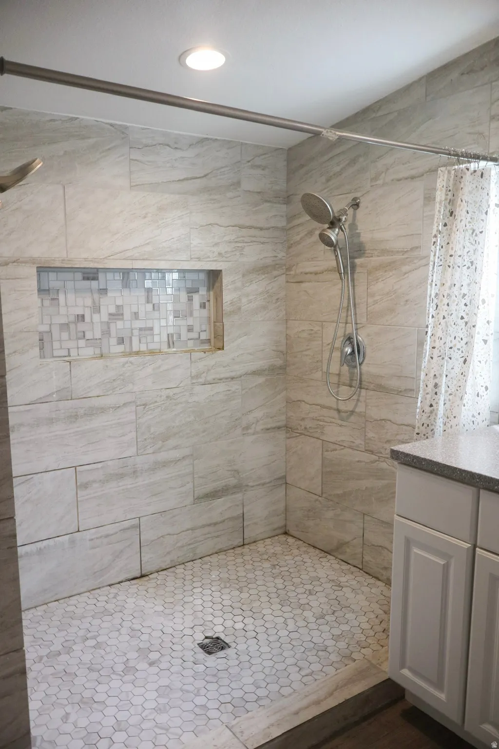 Full bath with a stall shower and vanity