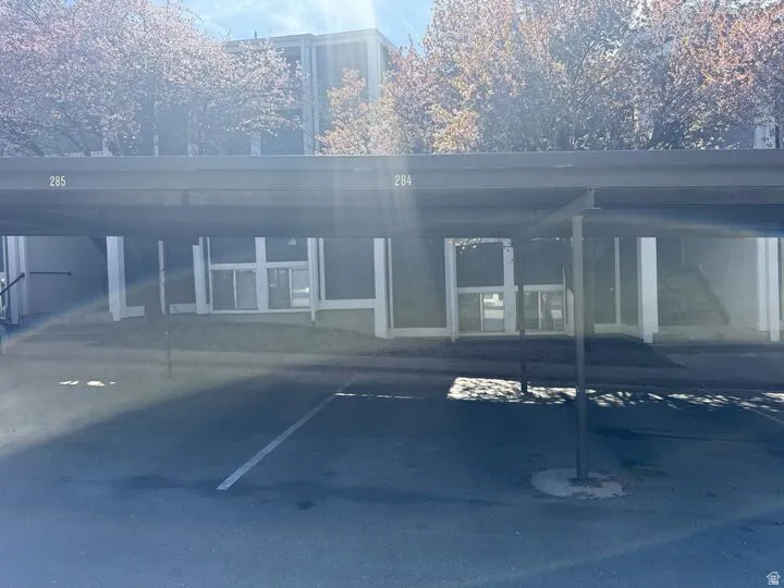 Exterior space featuring 1 covered parking spot