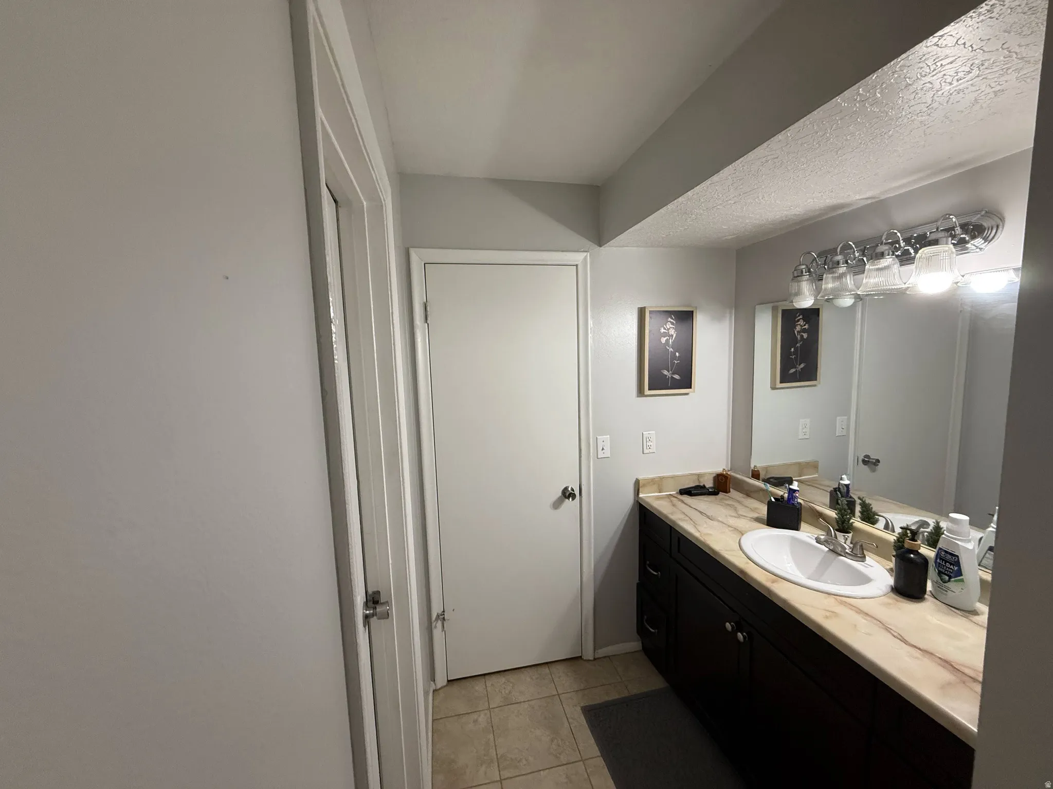 Bathroom featuring vanity, light tile patterned floor