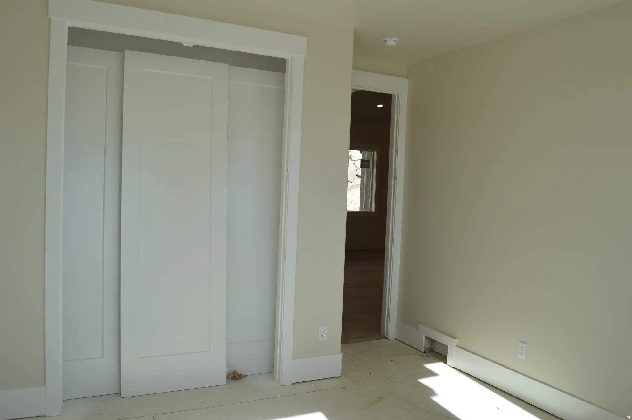 Unfurnished bedroom featuring a closet and a baseboard heating unit