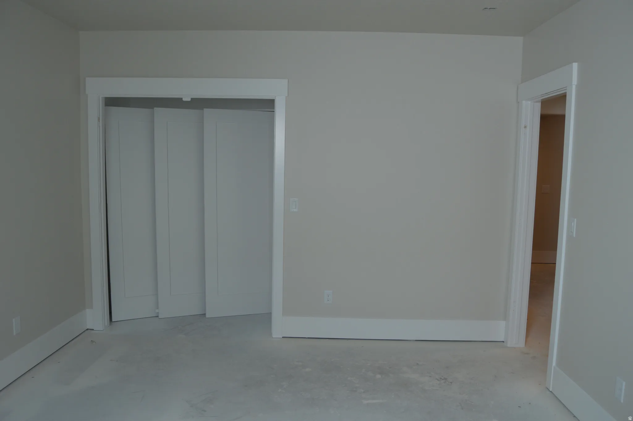 Unfurnished bedroom featuring a closet and unfinished concrete flooring