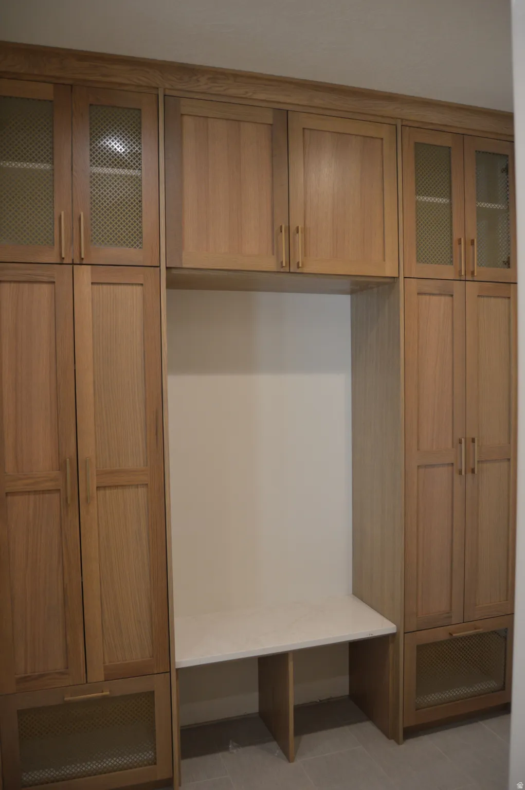 Mudroom with light tile patterned flooring