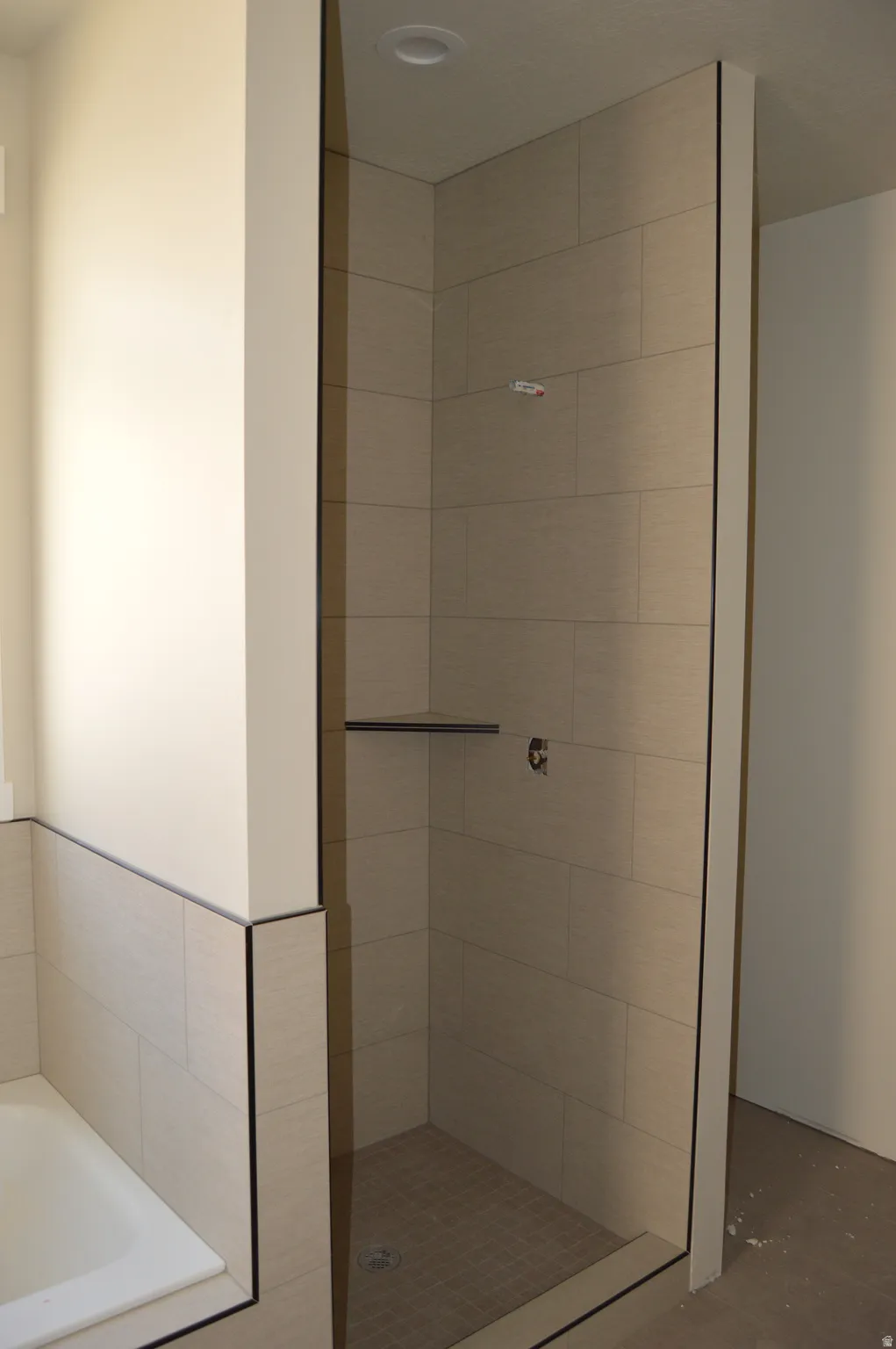 Bathroom with a garden tub and a shower stall