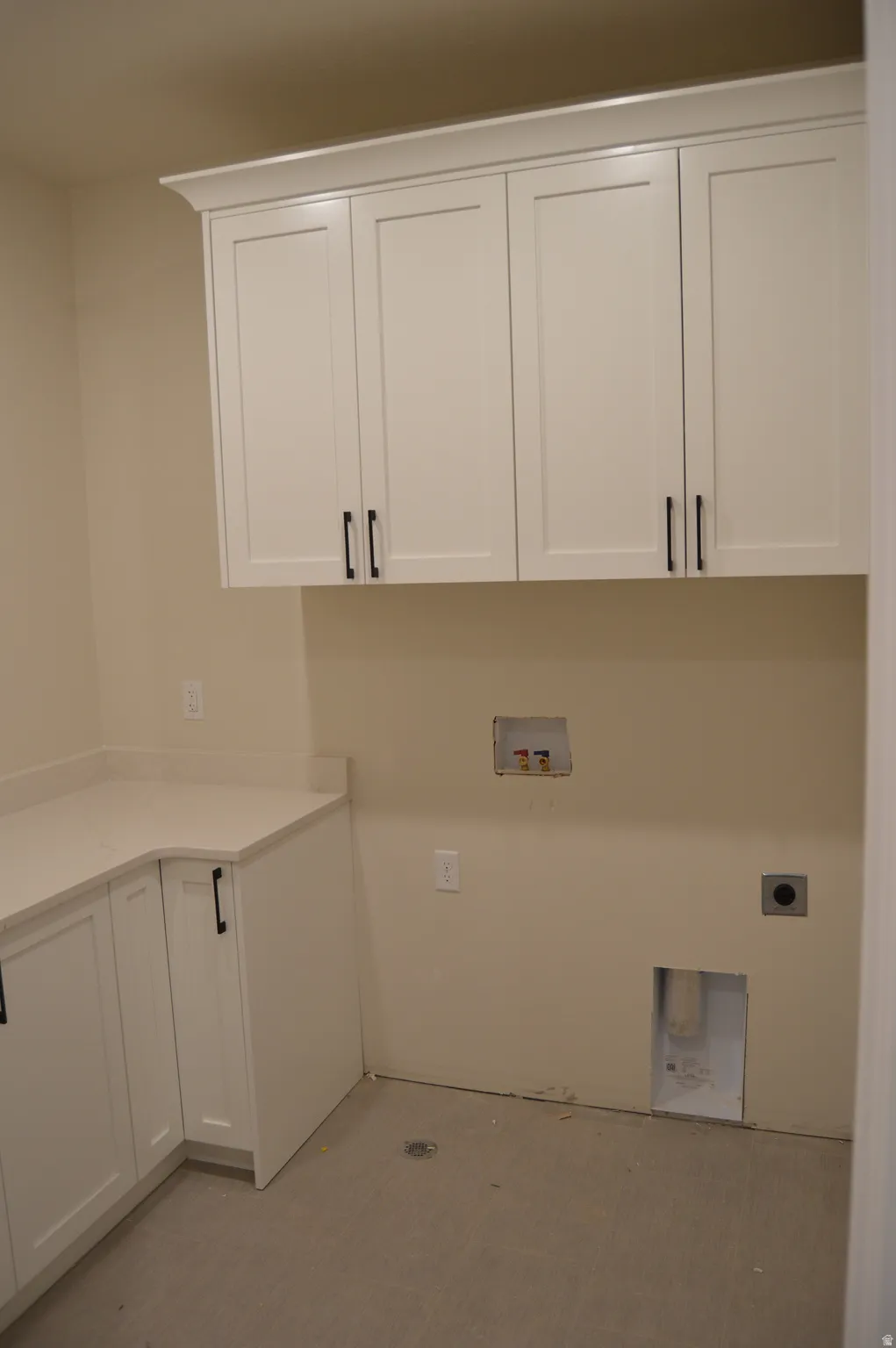 Laundry area with cabinet space, hookup for a washing machine, and hookup for an electric dryer