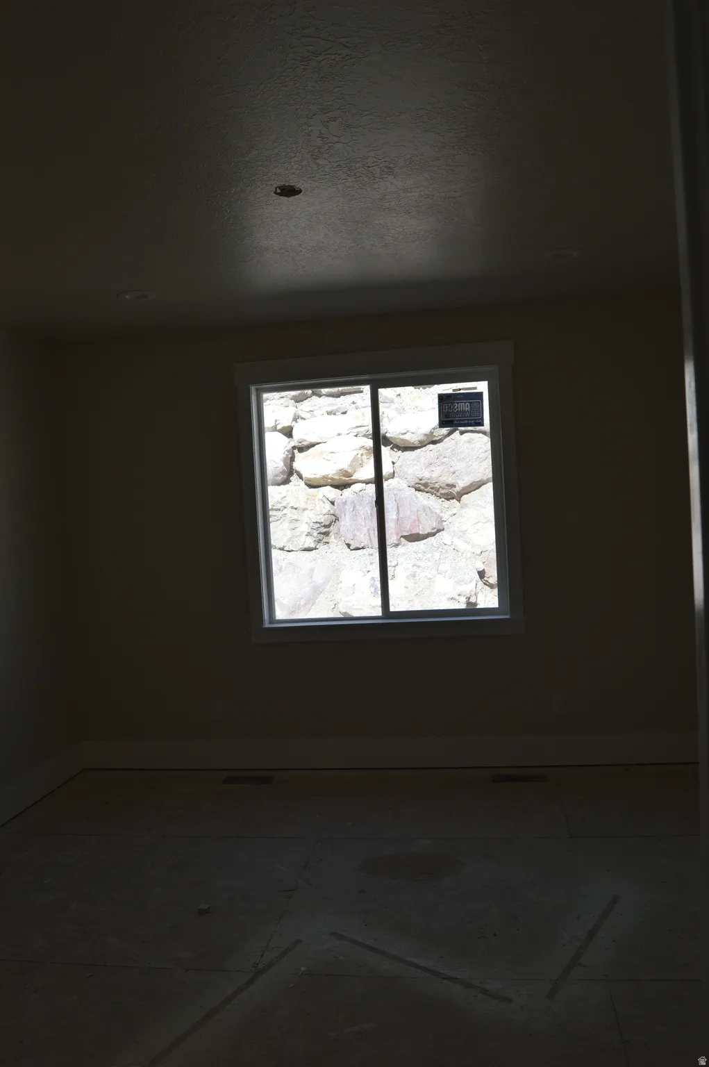 Spare room featuring baseboards and a textured ceiling