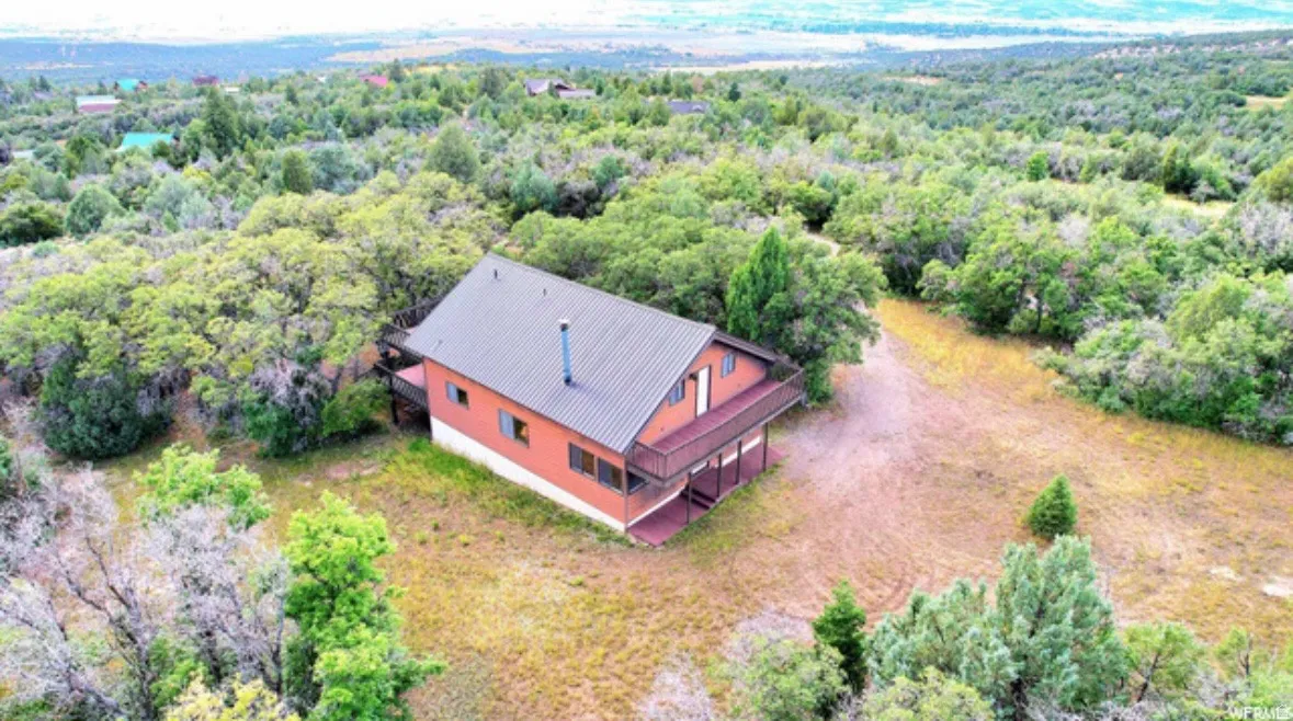 View of subject property featuring a forest