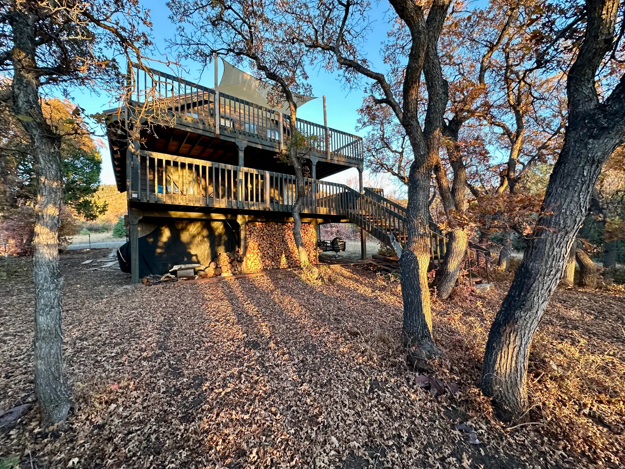 Rear view of property with a deck and stairway