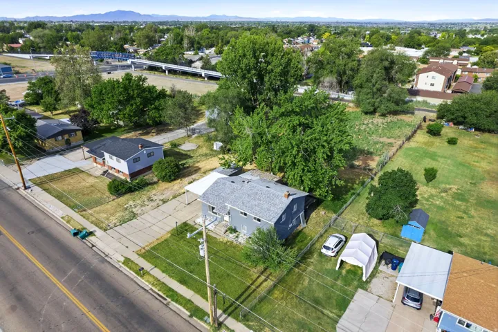 Aerial perspective showcasing a residential property with a gray exterior and dark shingle roof