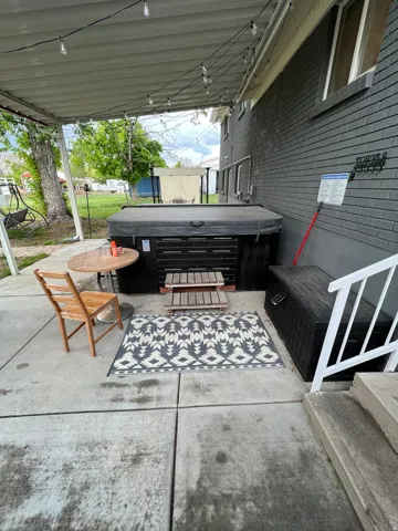 View of patio / terrace with a hot tub