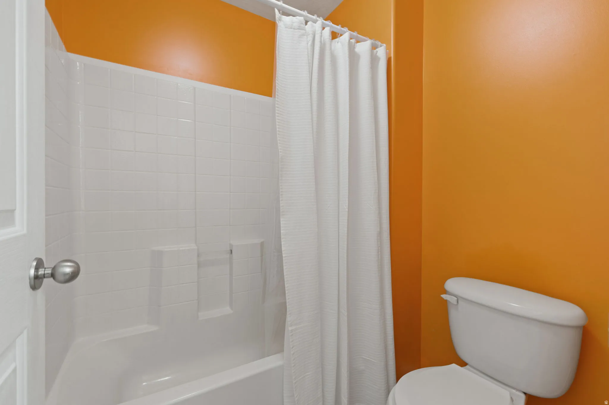 Full bathroom with toilet and shower / tub combo